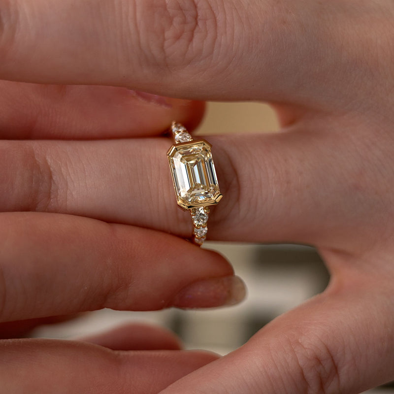 Deco Inspired Half Bezel East West Emerald Cut Diamond Ring