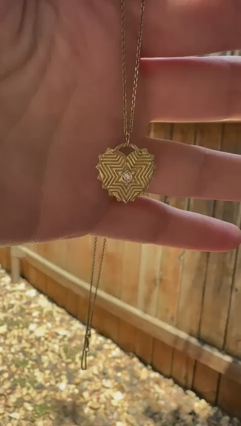 Video showing front and back detail of Engraved Magen David pendent front and back up close engraving detail of star of david and back haw a tiny heart